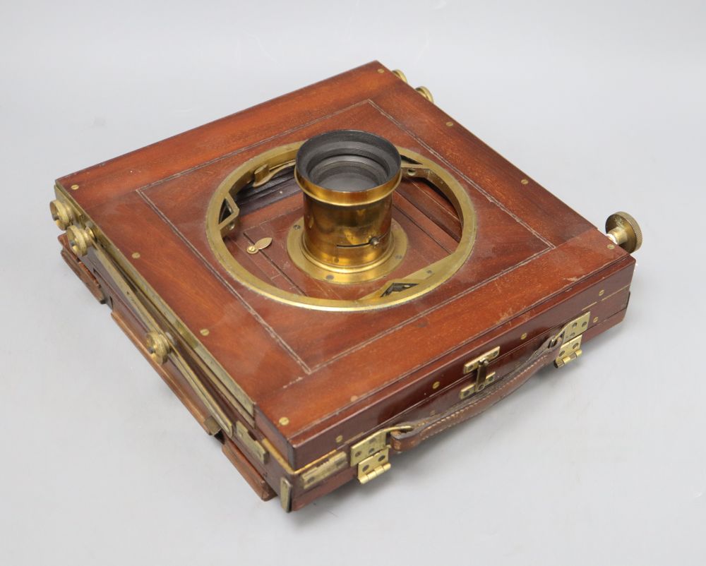 A Ross, London mahogany and brass half plate camera, plaque reading Presented by the Lords Commissioners of the Admiralty to